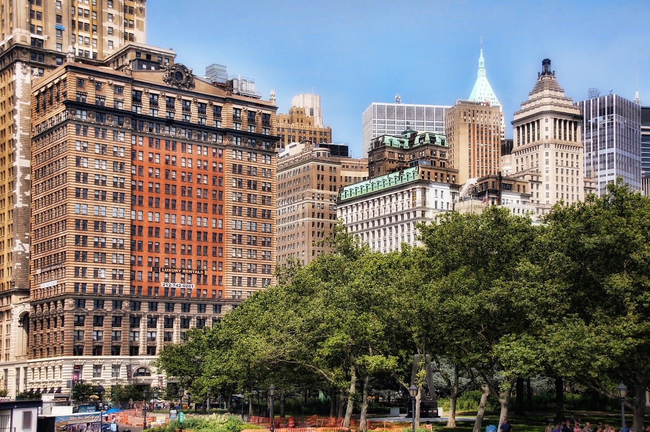 a city filled with lots of tall buildings, a photo, shutterstock, art nouveau, madison square garden, tonemapped, park on a bright sunny day, watch photo