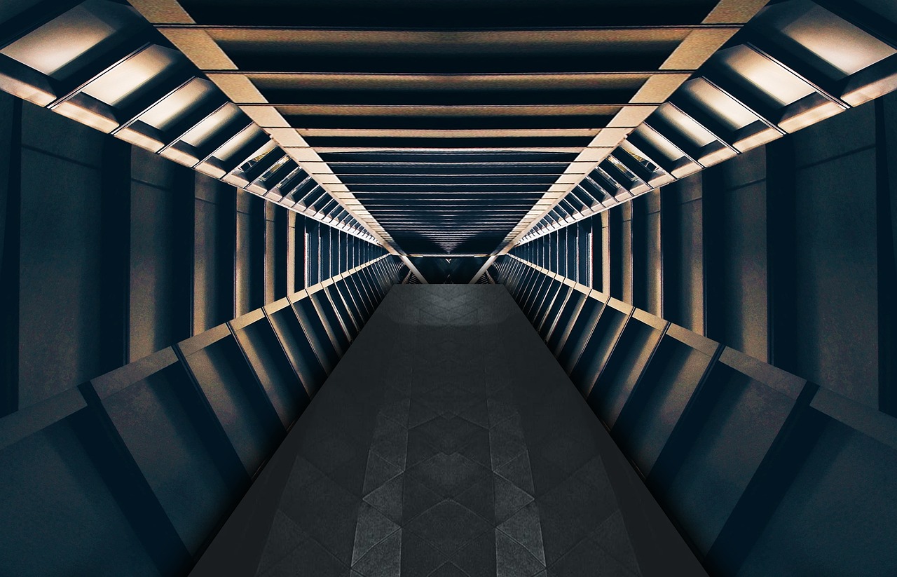 a long hallway with a light at the end of it, inspired by Beeple, unsplash contest winner, photo realistic symmetrical, metallic bridge, dark abstract background, geometric abstract