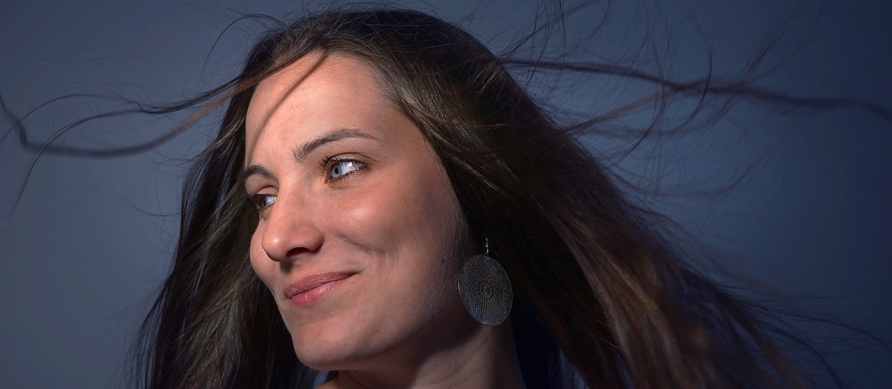 a close up of a woman with long hair, a portrait, photorealism, backlit ears, 30-year-old french woman, journalist photo, renata glasc