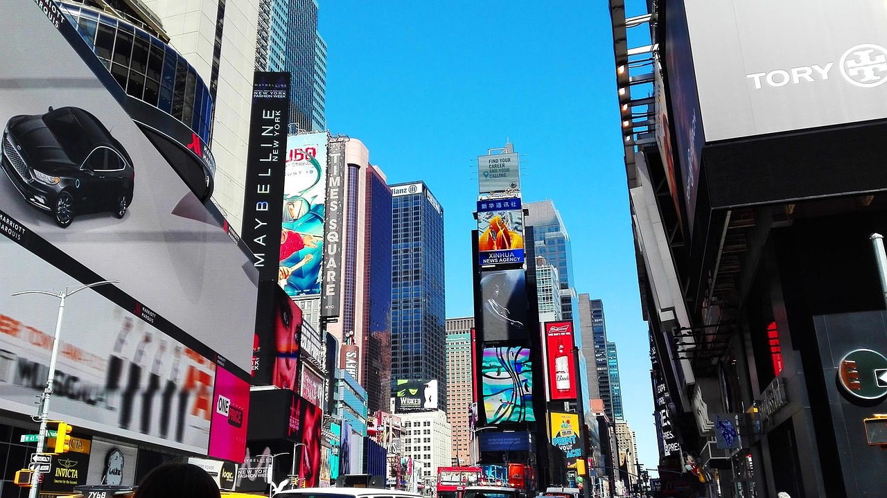 a city street filled with lots of tall buildings, a picture, time square, clear blue skies, oled, maybelline