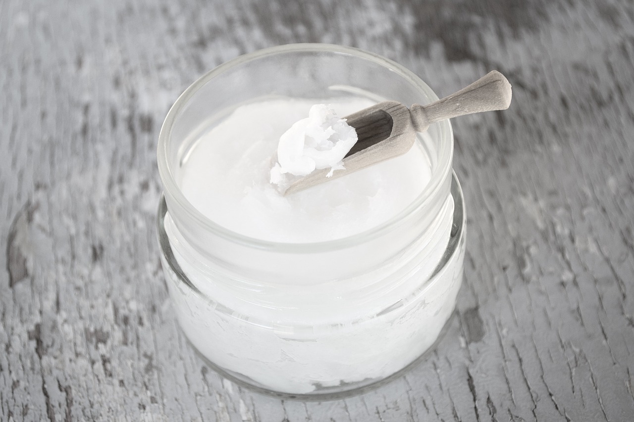 a jar of cream with a spoon sticking out of it, shutterstock, organic liquid textures, zinc white, close-up product photo, stock photo