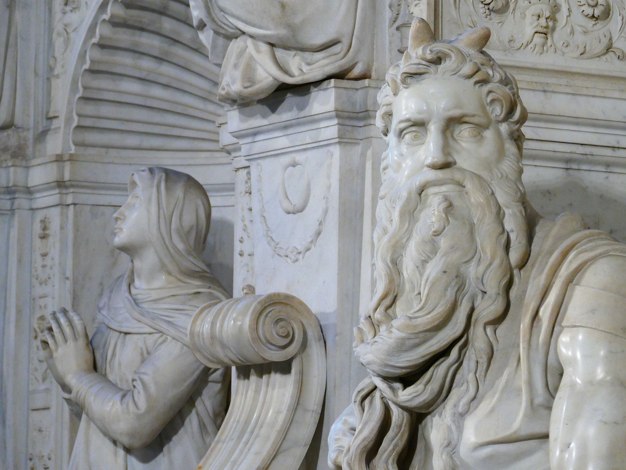 a statue of a man standing next to a statue of a woman, a marble sculpture, by Michelangelo Buonarotti, flickr, an ancient male bearded face, moses, depth detail, mausoleum