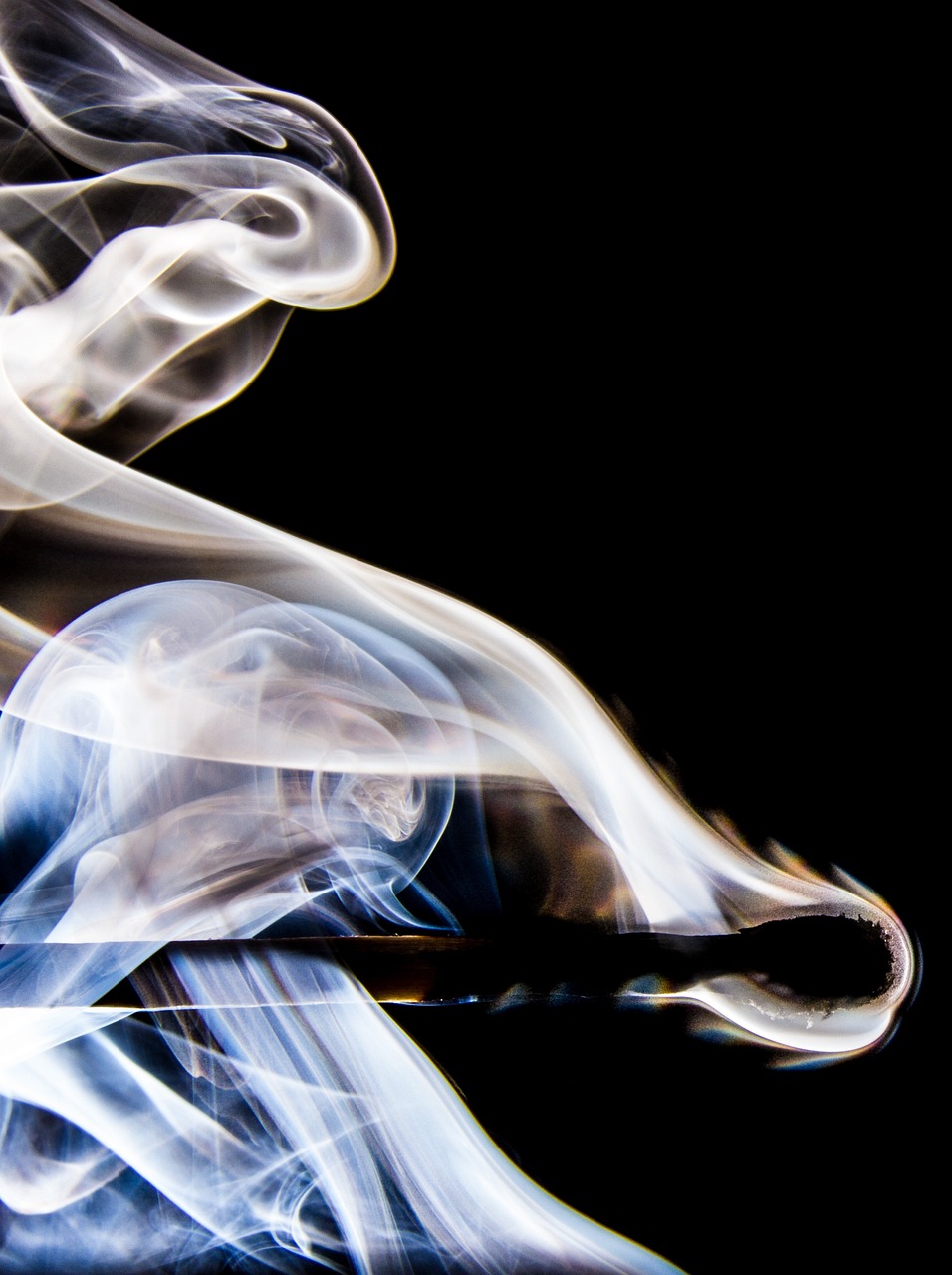 a close up of a cigarette with smoke coming out of it, a macro photograph, by Jan Rustem, abstract illusionism, photo of ghost of anubis, swirling flames, photo taken on a nikon, smoke around her