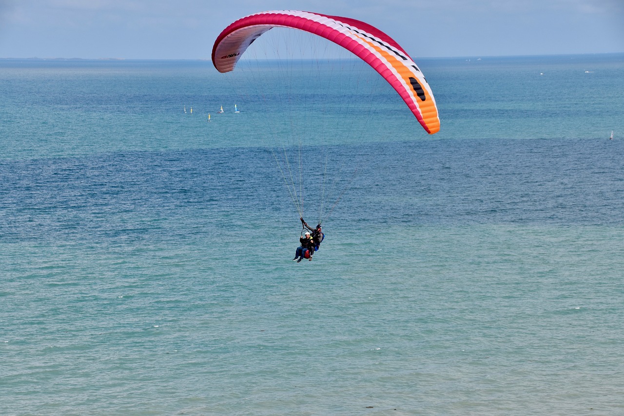 a person parasailing in the ocean on a sunny day, a photo, figuration libre, normandy, tourist photo, on the coast, watch photo