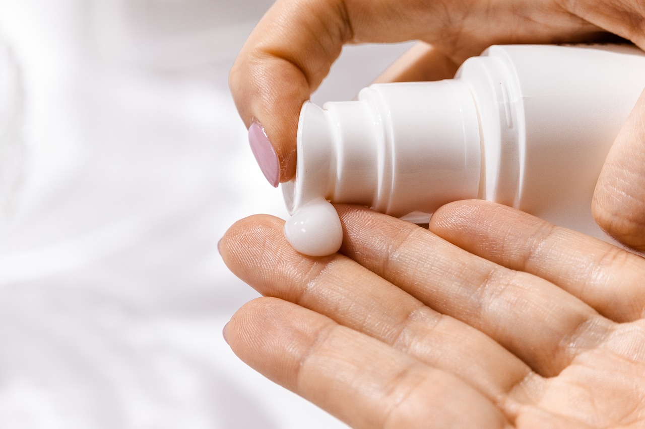 a person holding a bottle of lotion in their hand, a picture, by Matija Jama, shutterstock, plasticien, tiny details, contracept, abstract white fluid, candy treatments