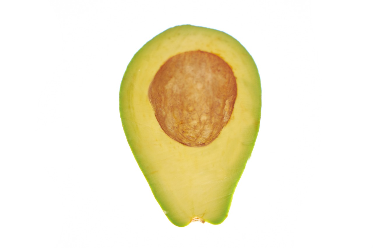 an avocado cut in half on a white surface, a picture, hurufiyya, detailed color scan, half body photo, high res photo, yellow aureole