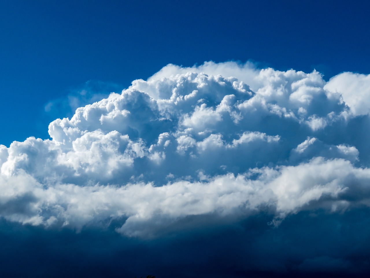 there is a plane that is flying in the sky, a portrait, by Hans Schwarz, shutterstock, giant cumulonimbus cloud, hdr detail, atmospheric blues, 3 / 4 extra - wide shot