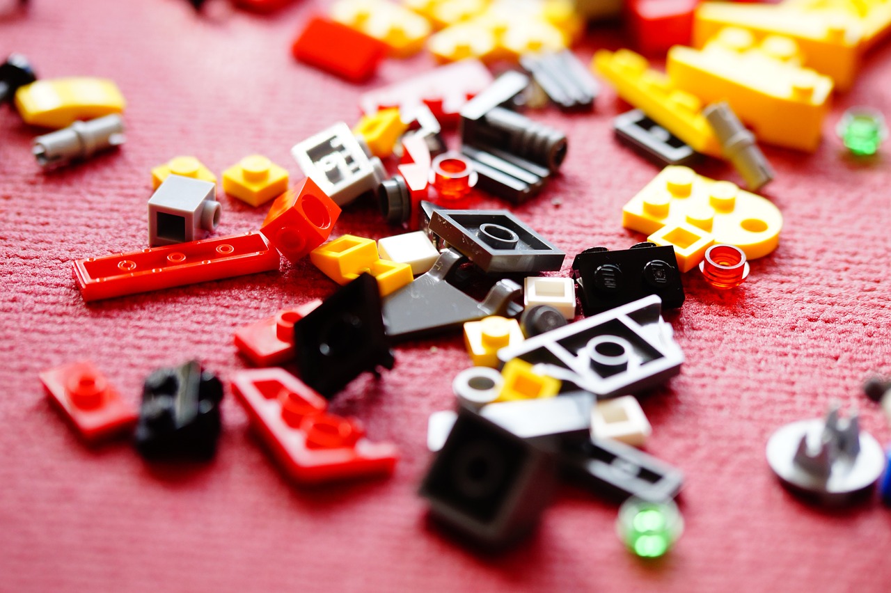a pile of legos sitting on top of a table, a picture, pexels, modular constructivism, in red background, super detail of each object, broken toys are scattered around, product introduction photo