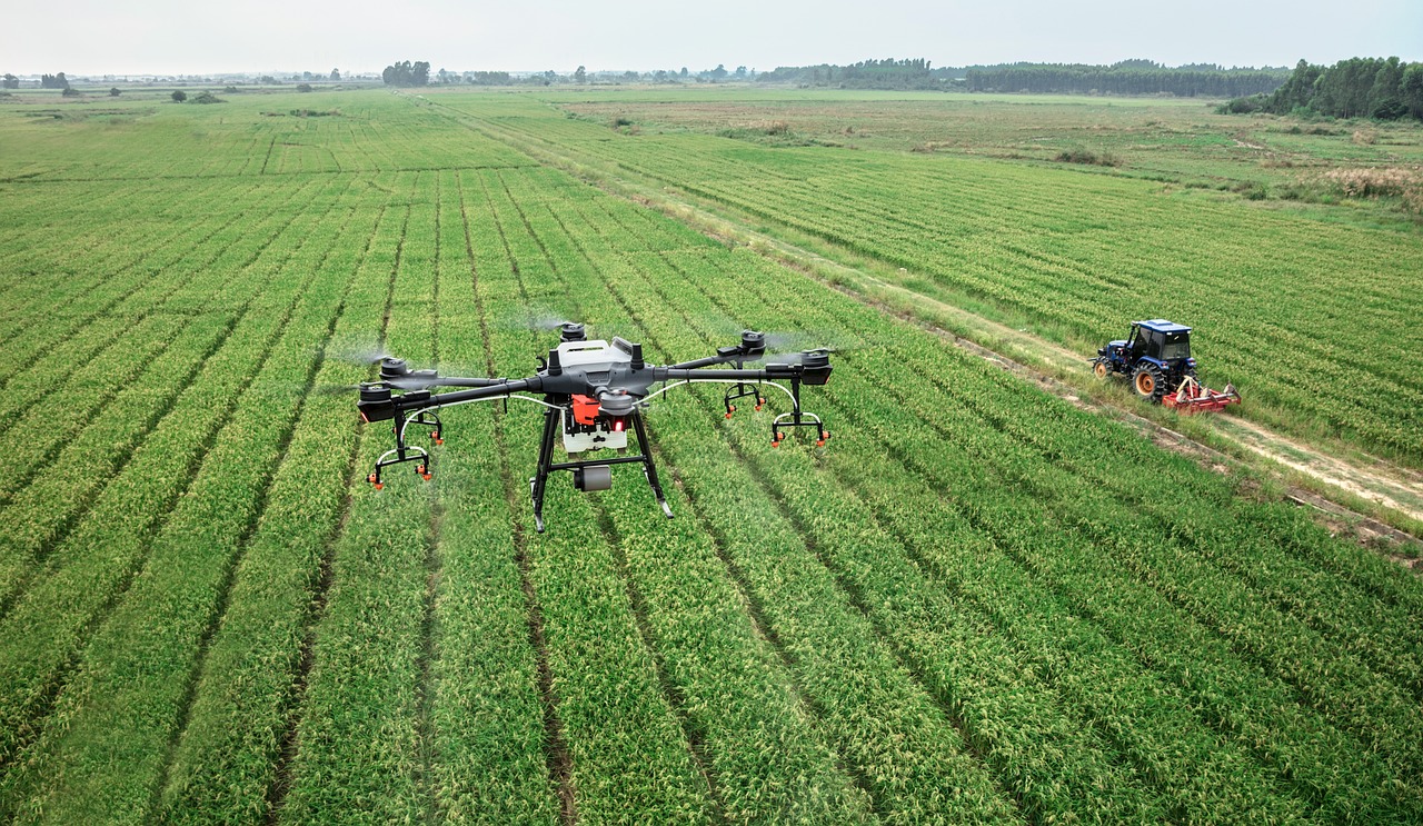 a large black drone flying over a lush green field, figuration libre, rice, view is centered on the robot, flying machinery, wide shot!!!!!!
