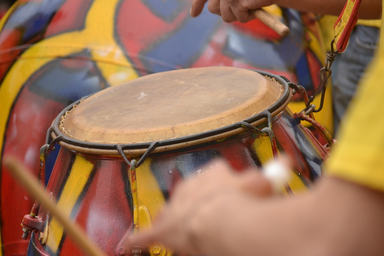 a close up of a person playing a drum, by Juan O'Gorman, shutterstock, process art, carnaval de barranquilla, drum pads, paiting, detailed zoom photo