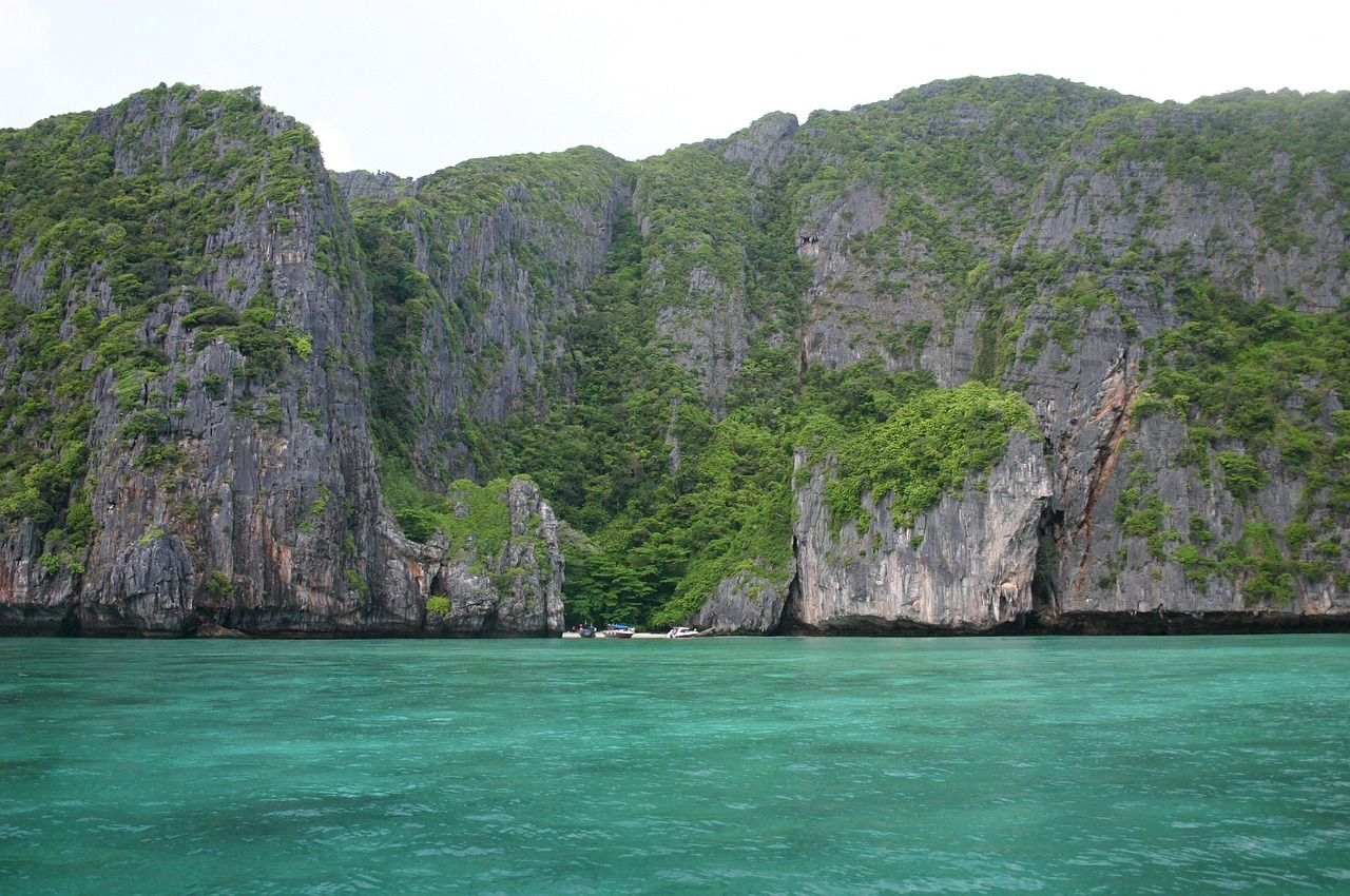 a body of water with a mountain in the background, a picture, island with cave, thai, coral reefs, very sharp photo