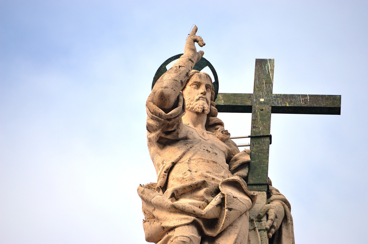 a statue of a woman holding a cross, inspired by Cagnaccio di San Pietro, shutterstock, figuration libre, the man looked up, stock photo, jesus riding a dragon, low angle photo