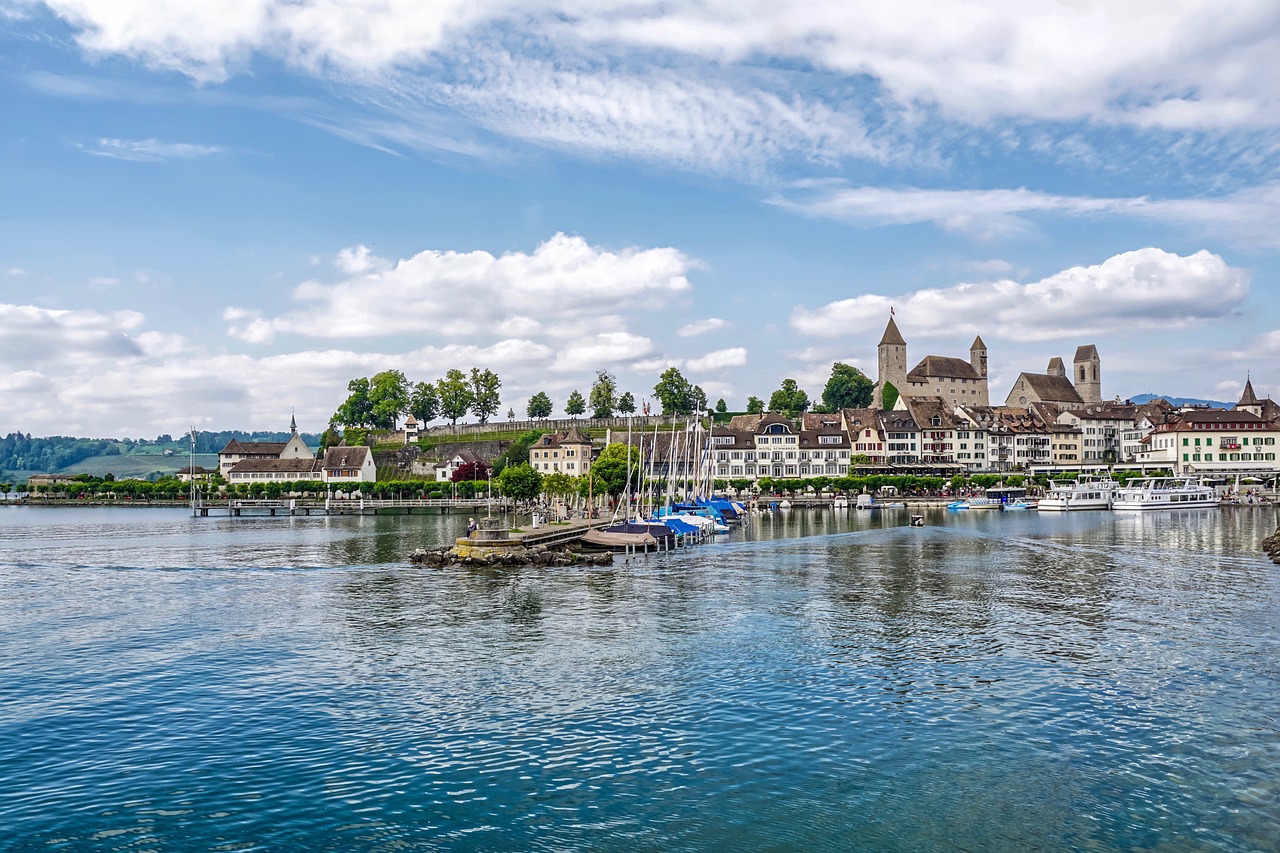 a body of water with a bunch of boats in it, by Hans Schwarz, shutterstock, grossmünster, the photo was taken from a boat, beautiful small town, tonemapping