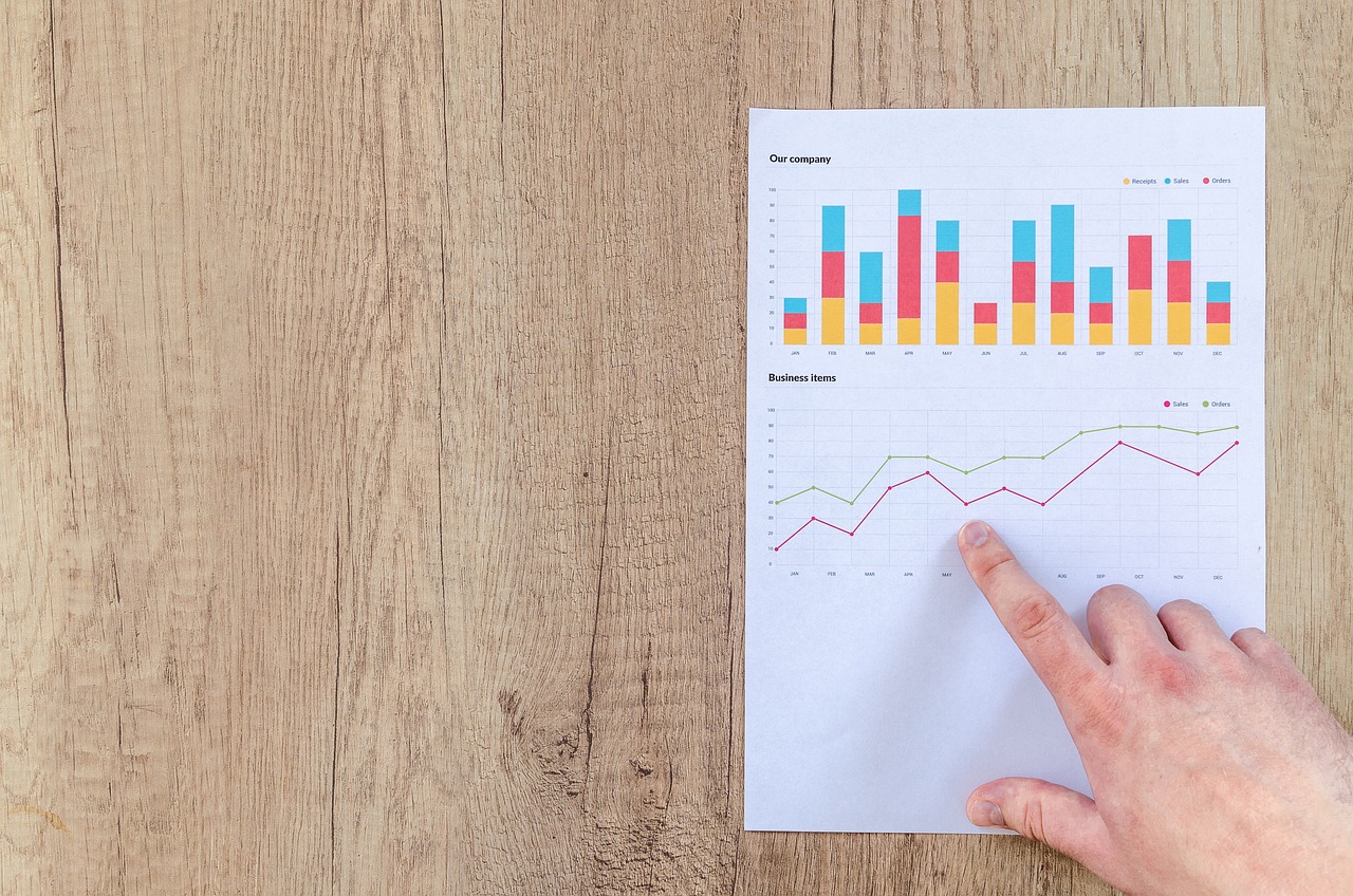 a person pointing at a chart on a piece of paper, shutterstock, bar charts, wooden, screencapture, low resolution