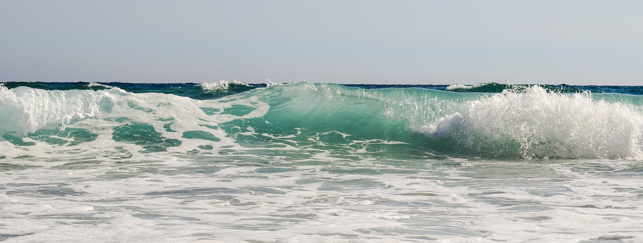 a man riding a wave on top of a surfboard, a picture, pixabay, fine art, glistening seafoam, the emerald coast, huge glistening muscles, beach pic