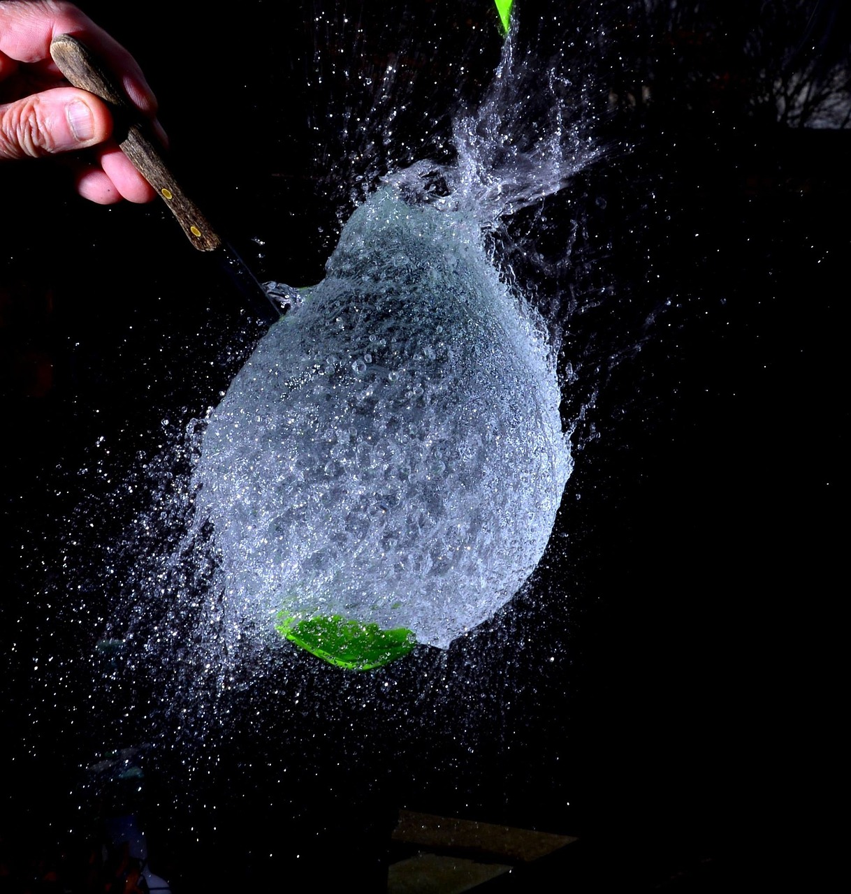 a person splashing water on a green leaf, a picture, flickr, plasticien, magic frozen ice phoenix egg, powdered sugar, flash photography at night, closeup shot