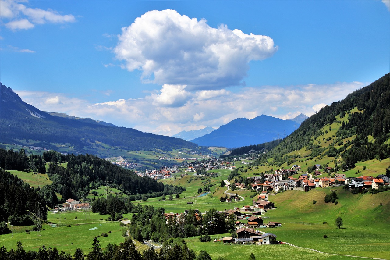a view of a small town in the mountains, by Werner Andermatt, flickr, renaissance, meadows on hills, orazio gentileschi style, big sky, hot summer sun