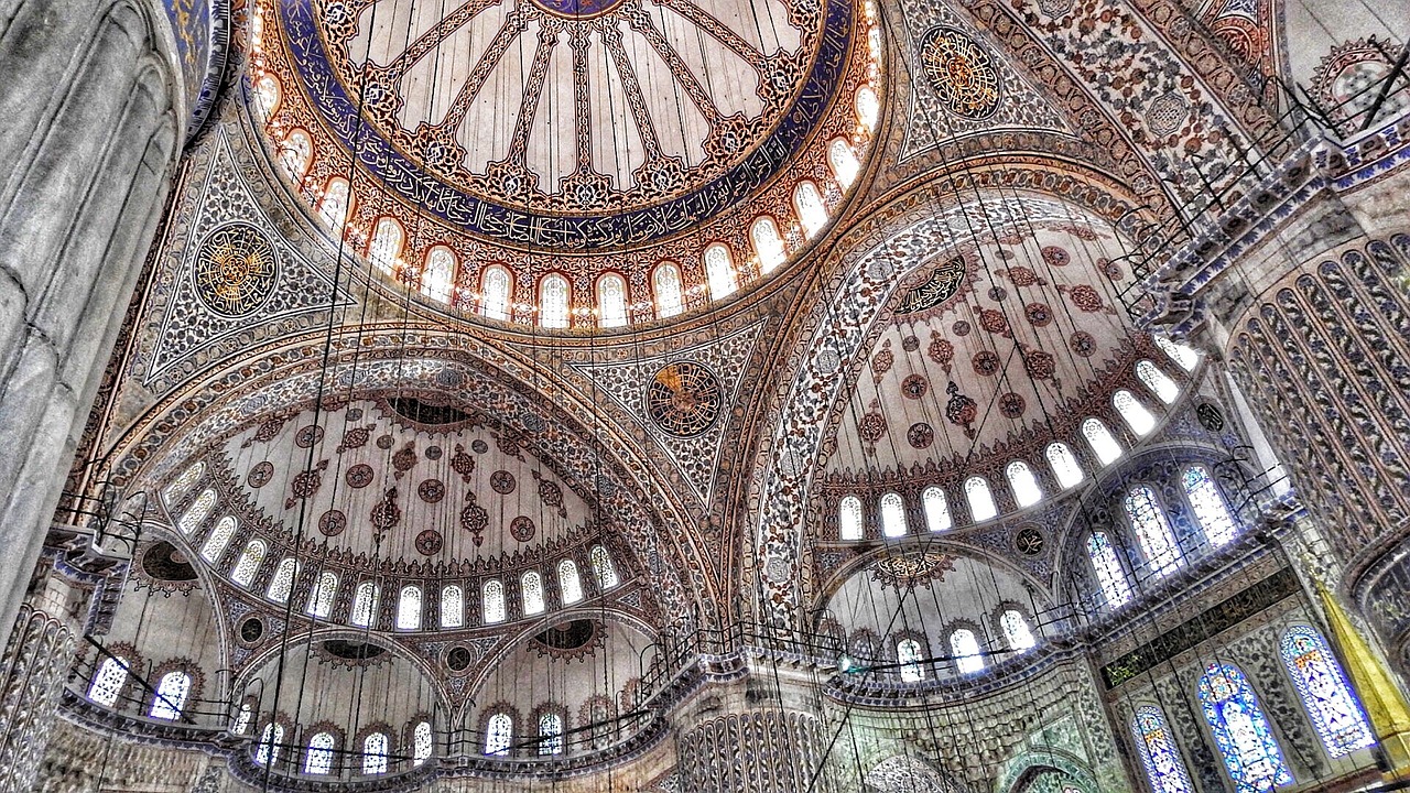 a picture of the inside of a building, a mosaic, trending on pixabay, arabesque, black domes and spires, ottoman sultan, chains hanging from ceiling, blue