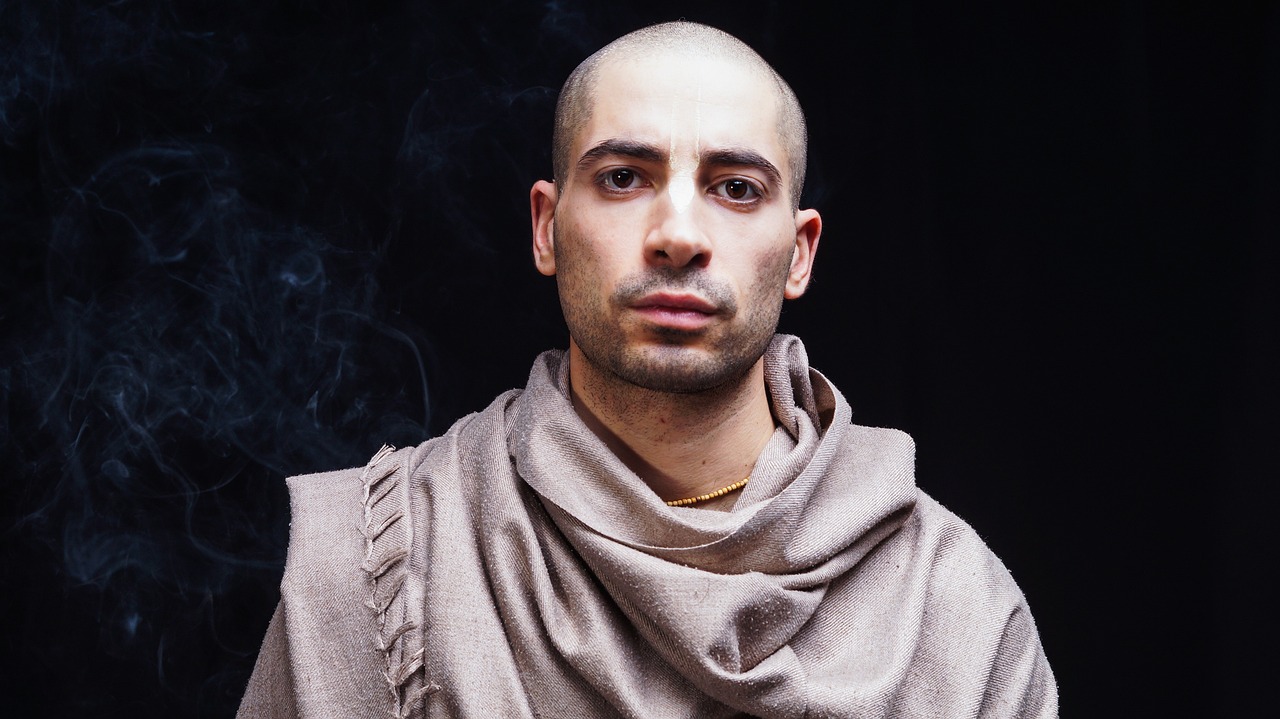a man with a scarf around his neck, a character portrait, inspired by Pietro Testa, renaissance, buzz cut, real life photo of a syrian man, wearing jedi robes and a sari, medieval alchemist in the dark