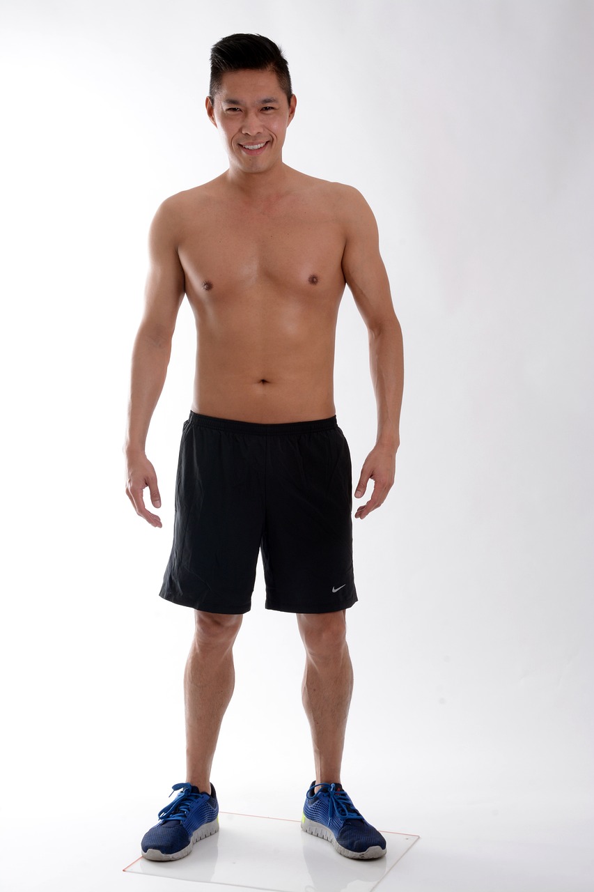 a man with no shirt standing on a scale, by Salomon van Abbé, flickr, minimalism, wearing black shorts, nike, vsx, full front view
