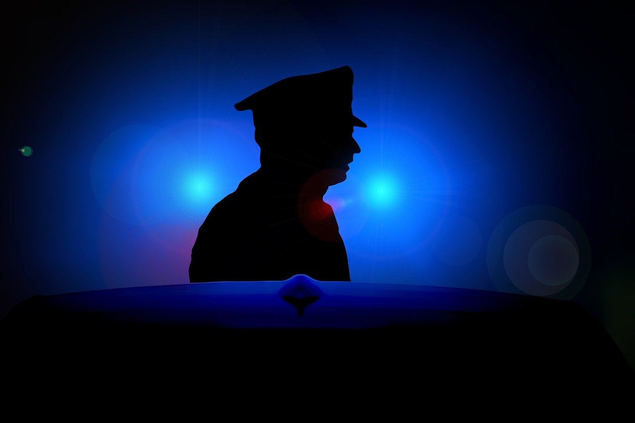 a silhouette of a police officer in the dark, an illustration of, point of view of visor wearer, an illustration, low saturated red and blue light, stockphoto