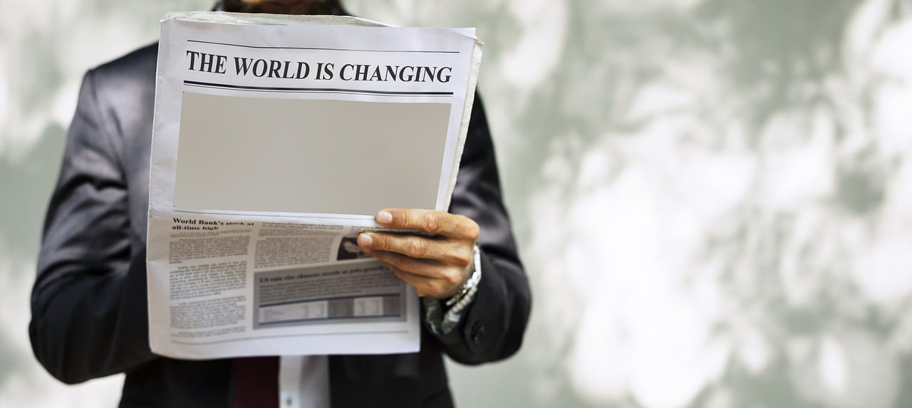 a man in a suit reading a newspaper, a picture, by Richard Carline, trending on pexels, happening, climate change, asking for change, futuristic world, woman holding sign