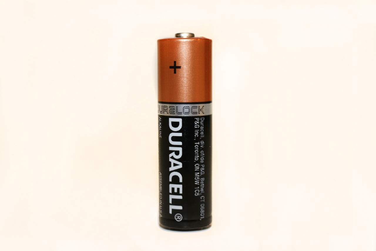 a close up of a battery on a white surface, a picture, by Rupert Shephard, dark orange, reference sheet white background, very realistic. low dark light, high quality product image”