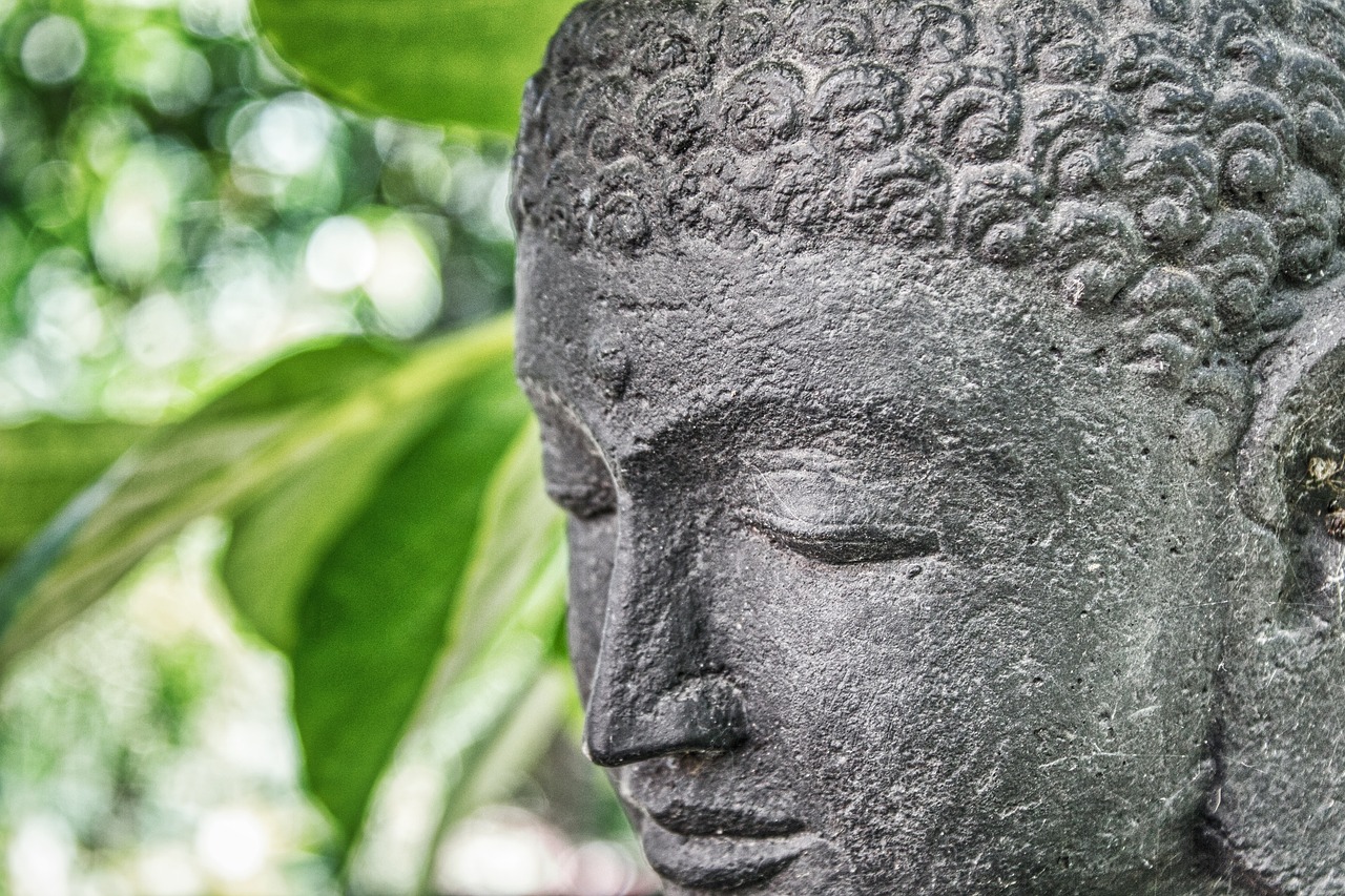 a close up of a statue of a person, a statue, shutterstock, concrete art, zen natural background, south east asian with round face, portrait mode photo, lush surroundings