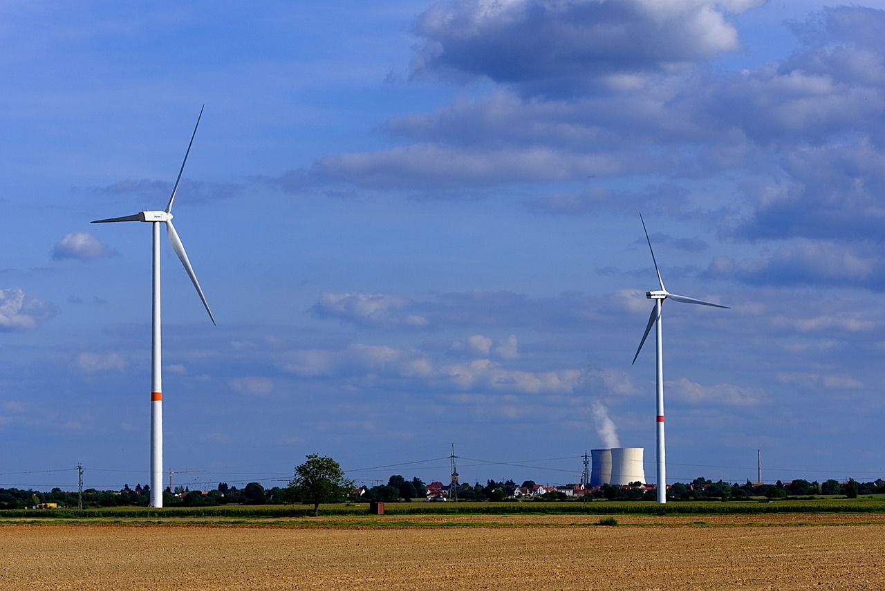 a couple of wind turbines sitting on top of a field, a picture, bauhaus, nuclear power plant, turnaround, andreas m wiese, photos