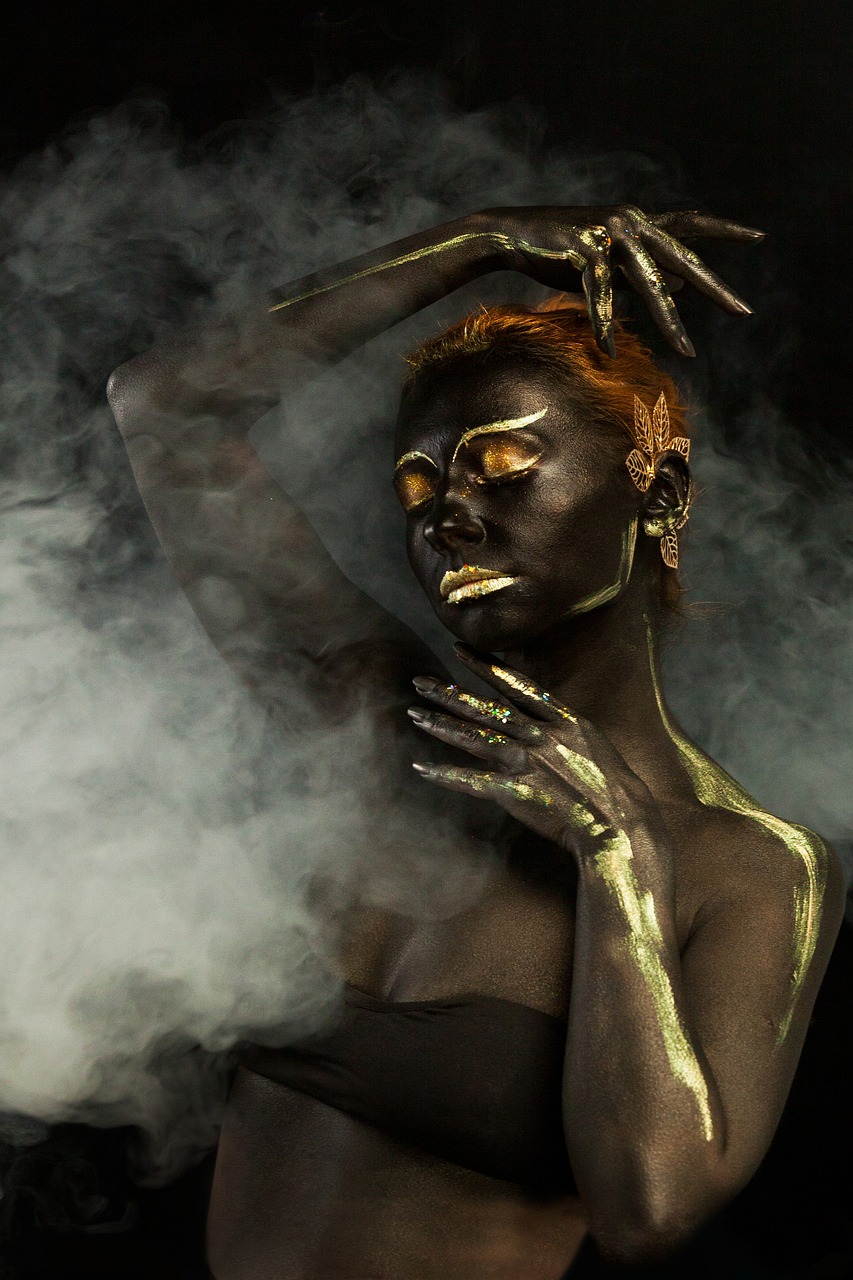a woman with gold paint on her face and hands, inspired by Hedi Xandt, art photography, volumetric smoke, african female android, fullbody painting, gray alien