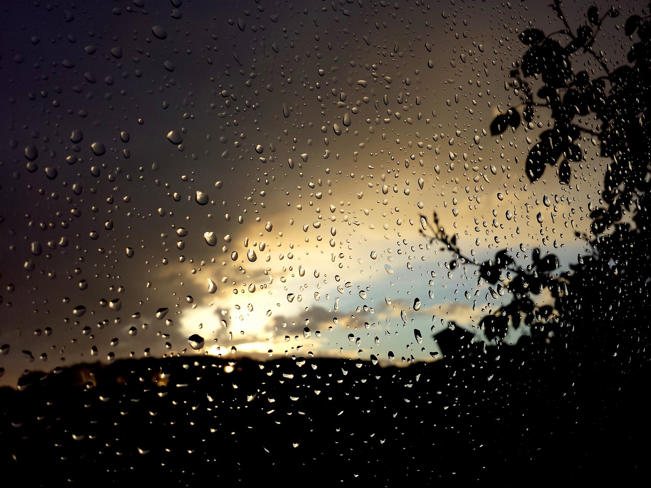 a view of a sunset through a rain covered window, romanticism, tear drops, shot on gopro9, blog-photo, low angle photo