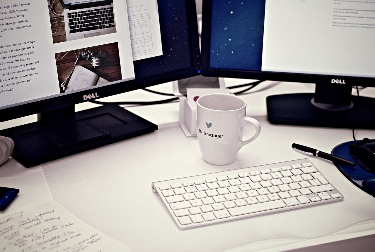 a desk with two computer monitors and a keyboard, by Karl Buesgen, tumblr, is ((drinking a cup of tea)), white sleeves, computer wallpaper, beautiful design