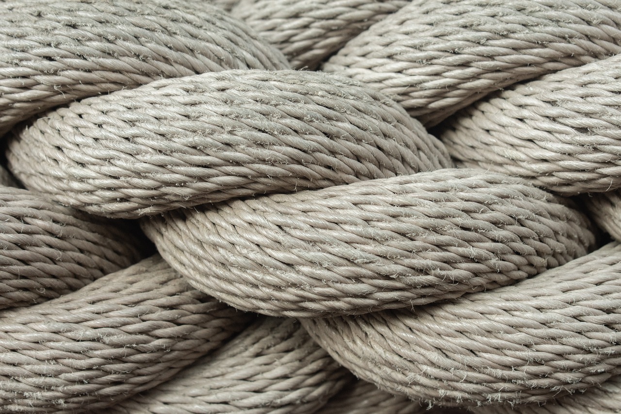 a close up of a pile of rope, inspired by W. Lindsay Cable, shutterstock, modernism, taupe, 35 mm product photo”, 5 5 mm photo, silk