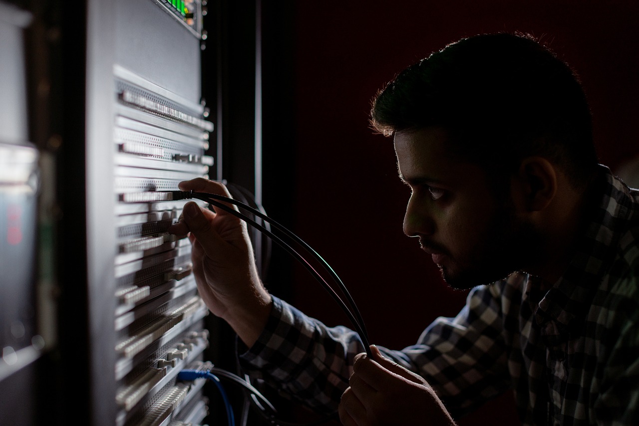 a man working on a computer in a dark room, shutterstock, servers, professional closeup photo, climbing, high res photo
