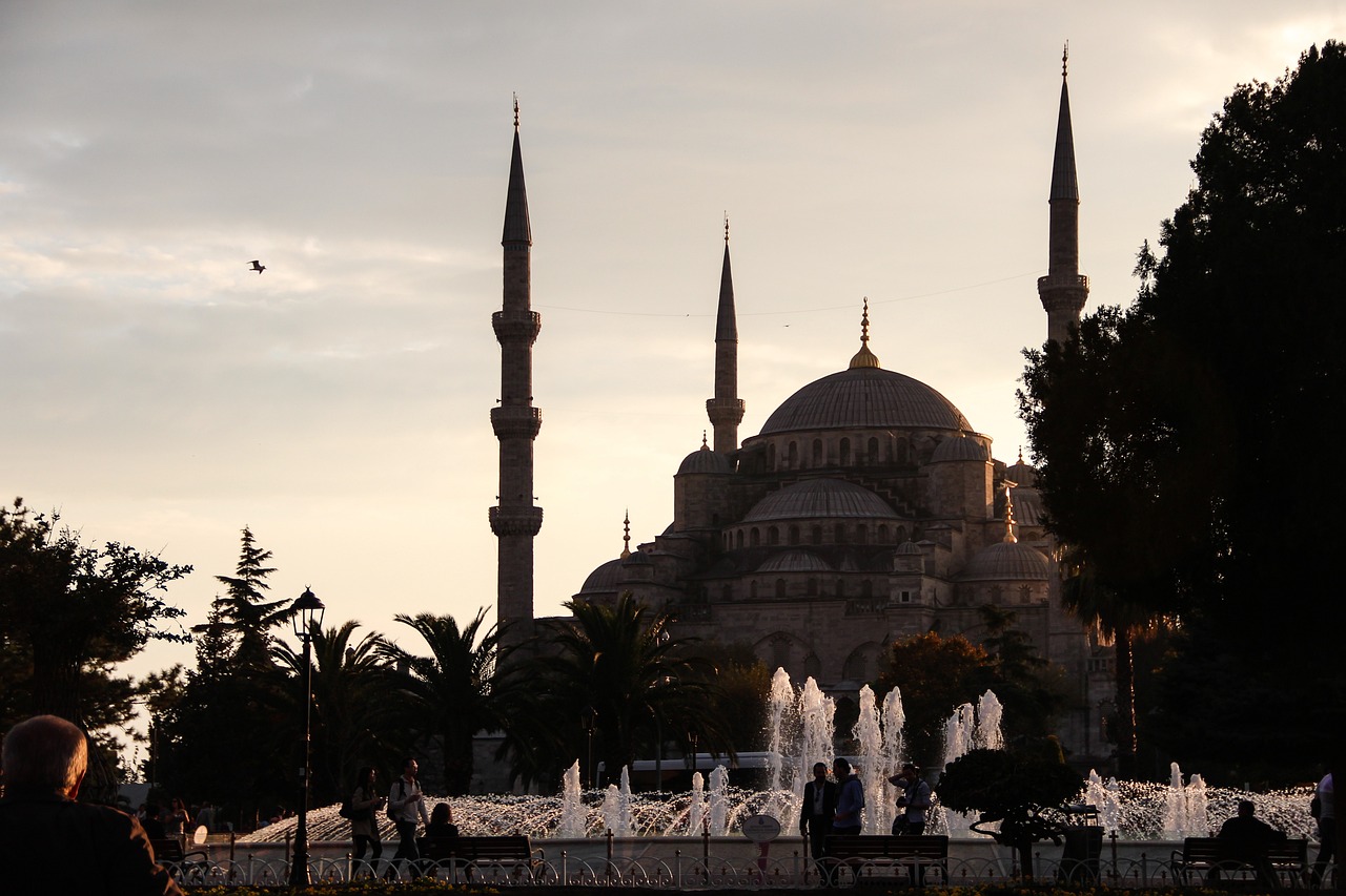 a large building with a fountain in front of it, a picture, shutterstock, hurufiyya, silhouetted, istanbul, cathedral in the background, afp