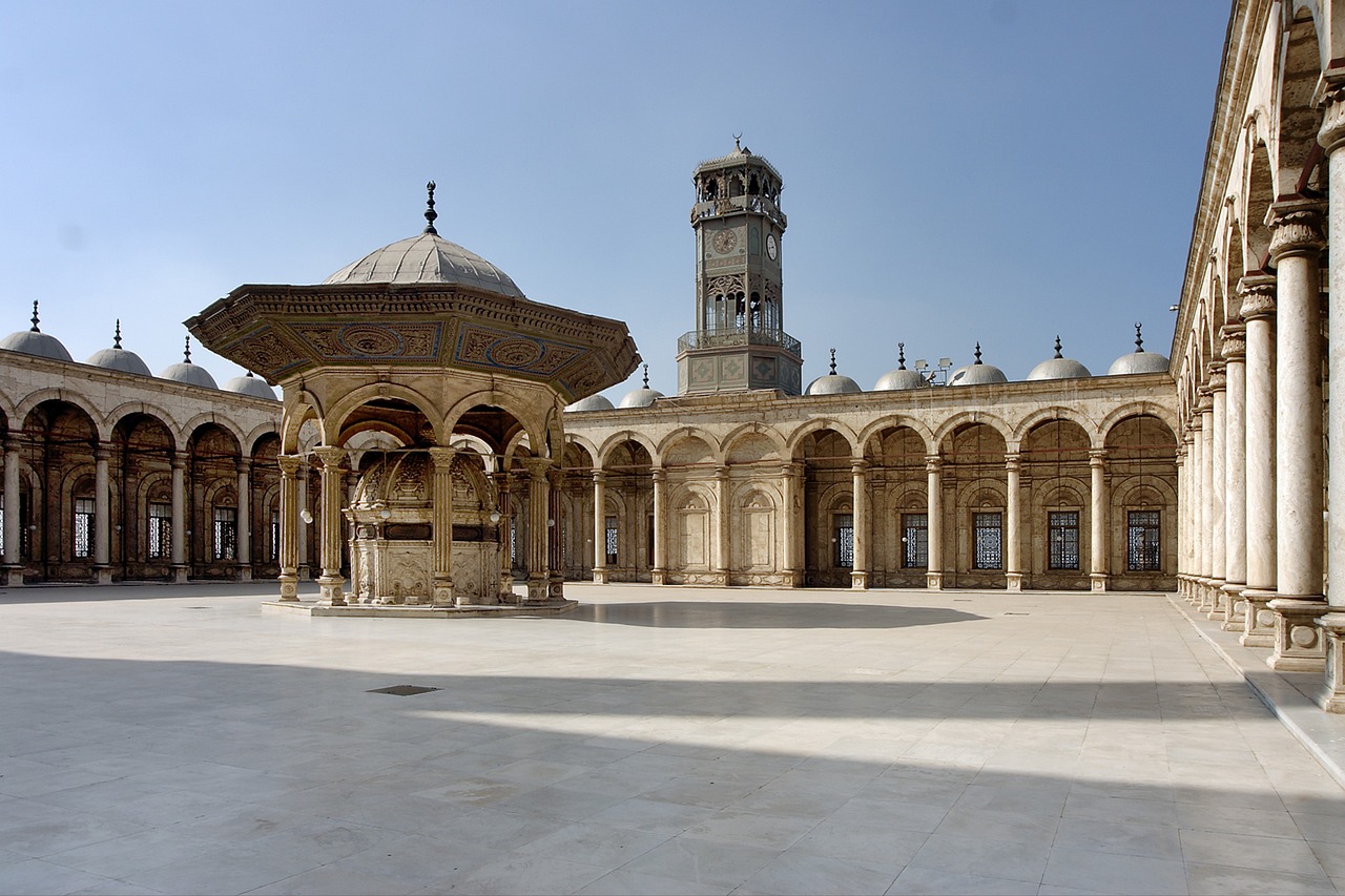 a courtyard with a fountain and a clock tower, by Kamāl ud-Dīn Behzād, flickr, wide panoramic shot, colonnade, dome, ivory