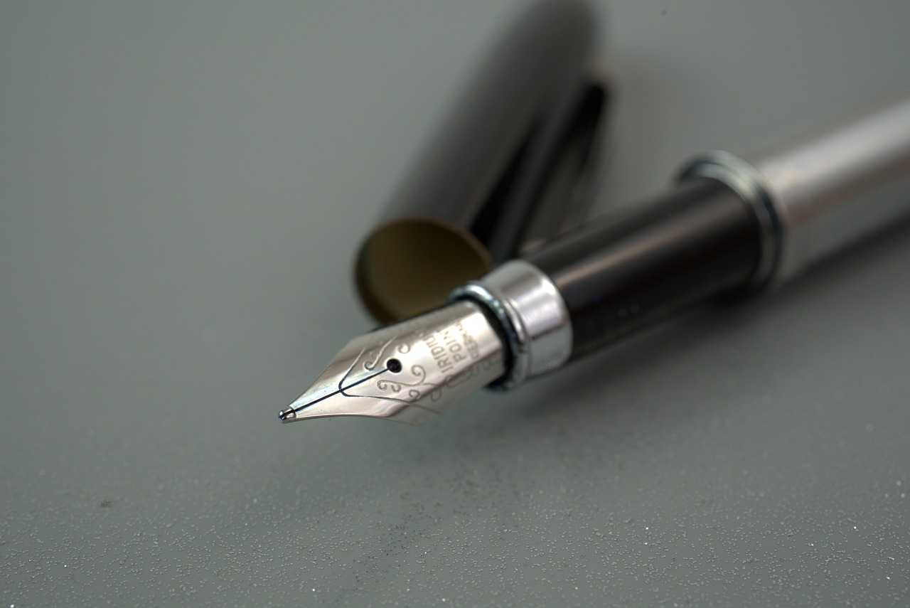 a fountain pen sitting on top of a table, a macro photograph, minimalism, highly detailed product photo