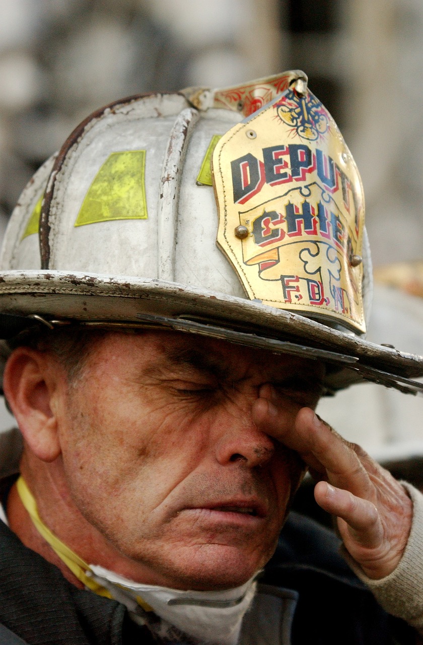 a close up of a person wearing a fireman's hat, a photo, by Dan Frazier, crying eyes closed!, photograph credit: ap, 9 / 1 1, hand on his cheek