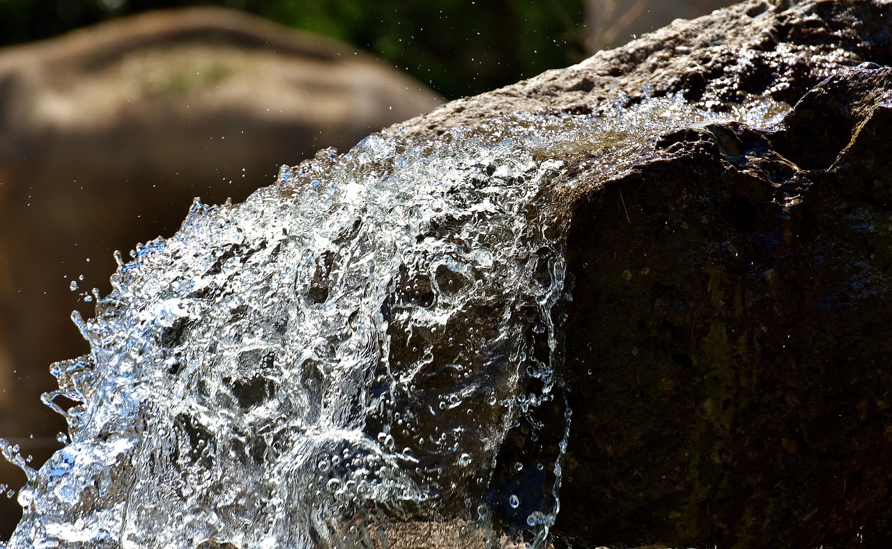 a close up of water coming out of a rock, a picture, by Tom Carapic, renaissance, sparkling in the sunlight, accurate and detailed, water fountain, random detail