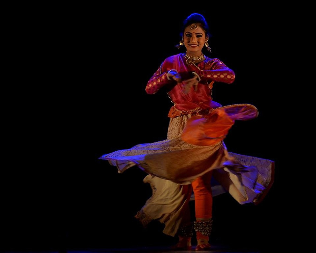 a woman that is standing in the dark, by Sunil Das, arabesque, stage photography, in swirling harmony, [ colourful, peredvishniki