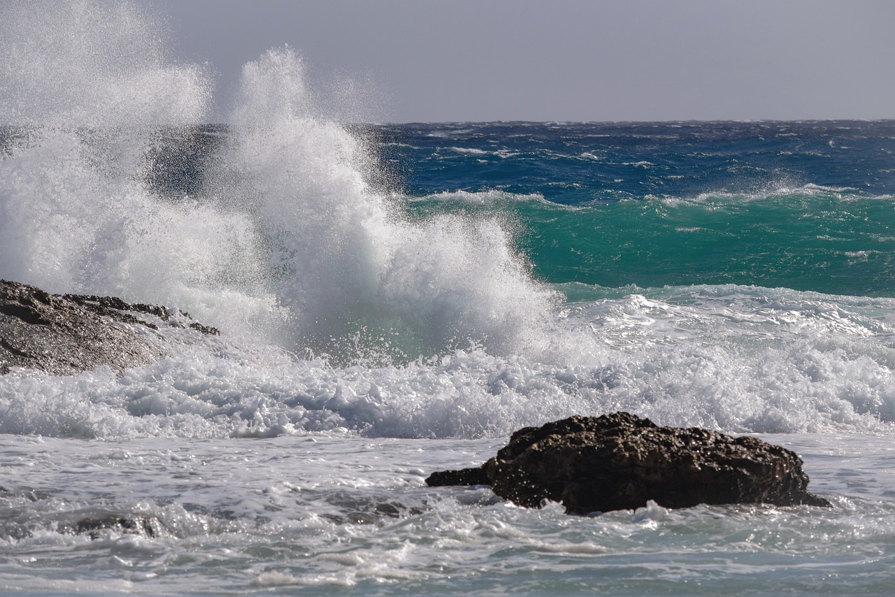 a person riding a surfboard on top of a wave, a picture, figuration libre, aruba, waves crashing at rocks, today\'s featured photograph 4k, high winds