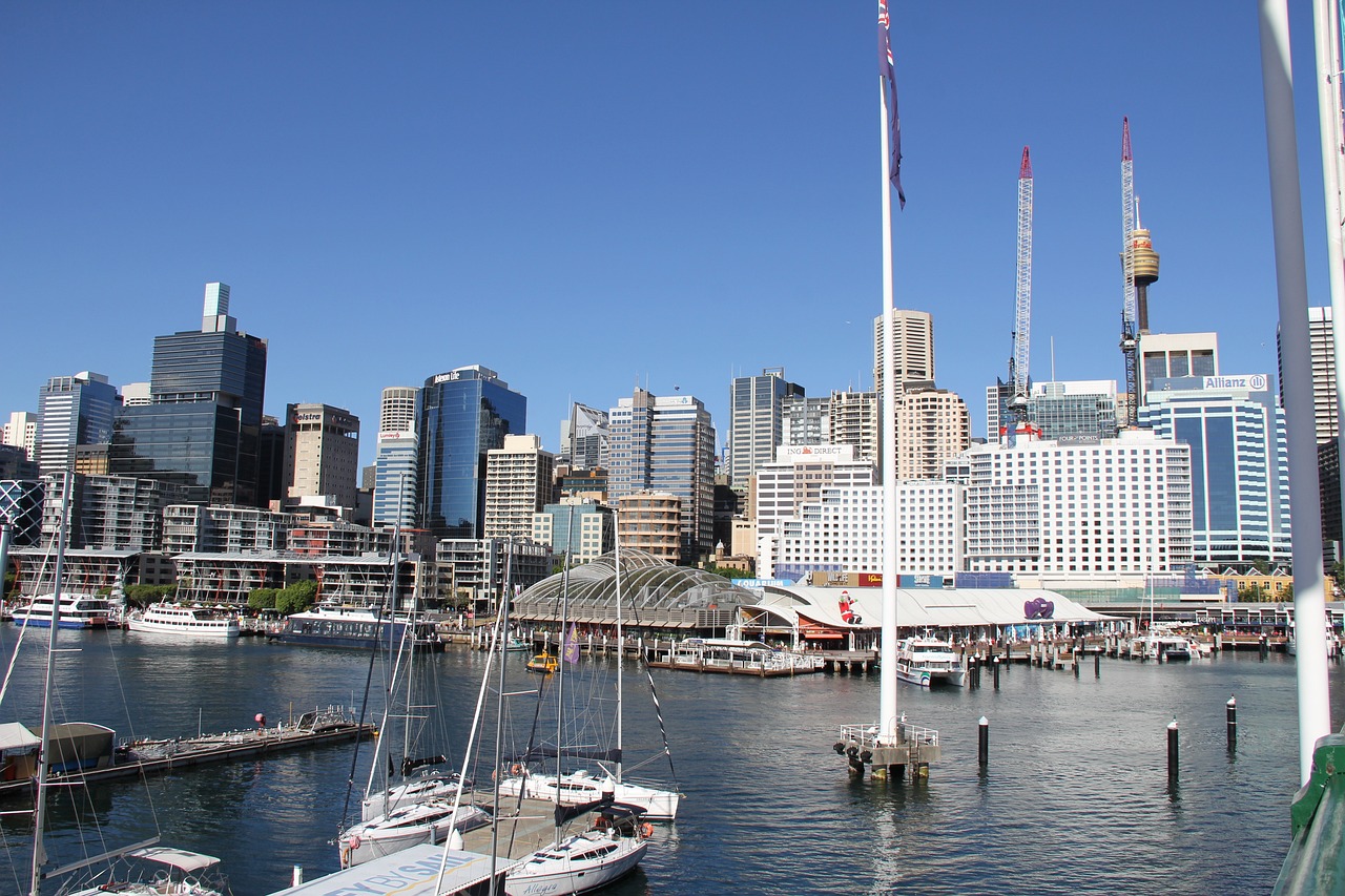 a large body of water with a bunch of boats in it, inspired by Sydney Carline, flickr, hurufiyya, entertainment district, buildings, docked at harbor, beautiful daylight