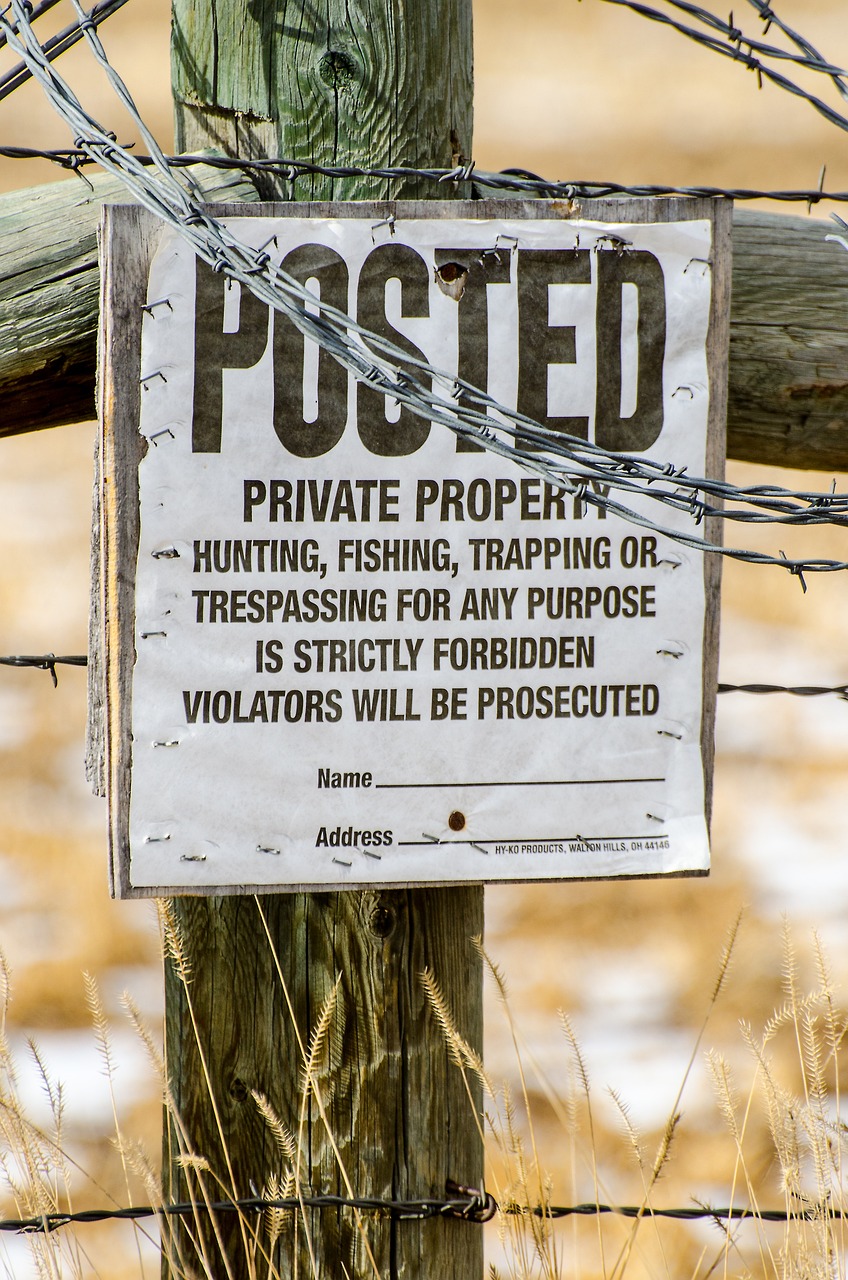 a wooden post with a sign attached to it, a poster, by Linda Sutton, shutterstock, hunted, colorado, contain, forbidden