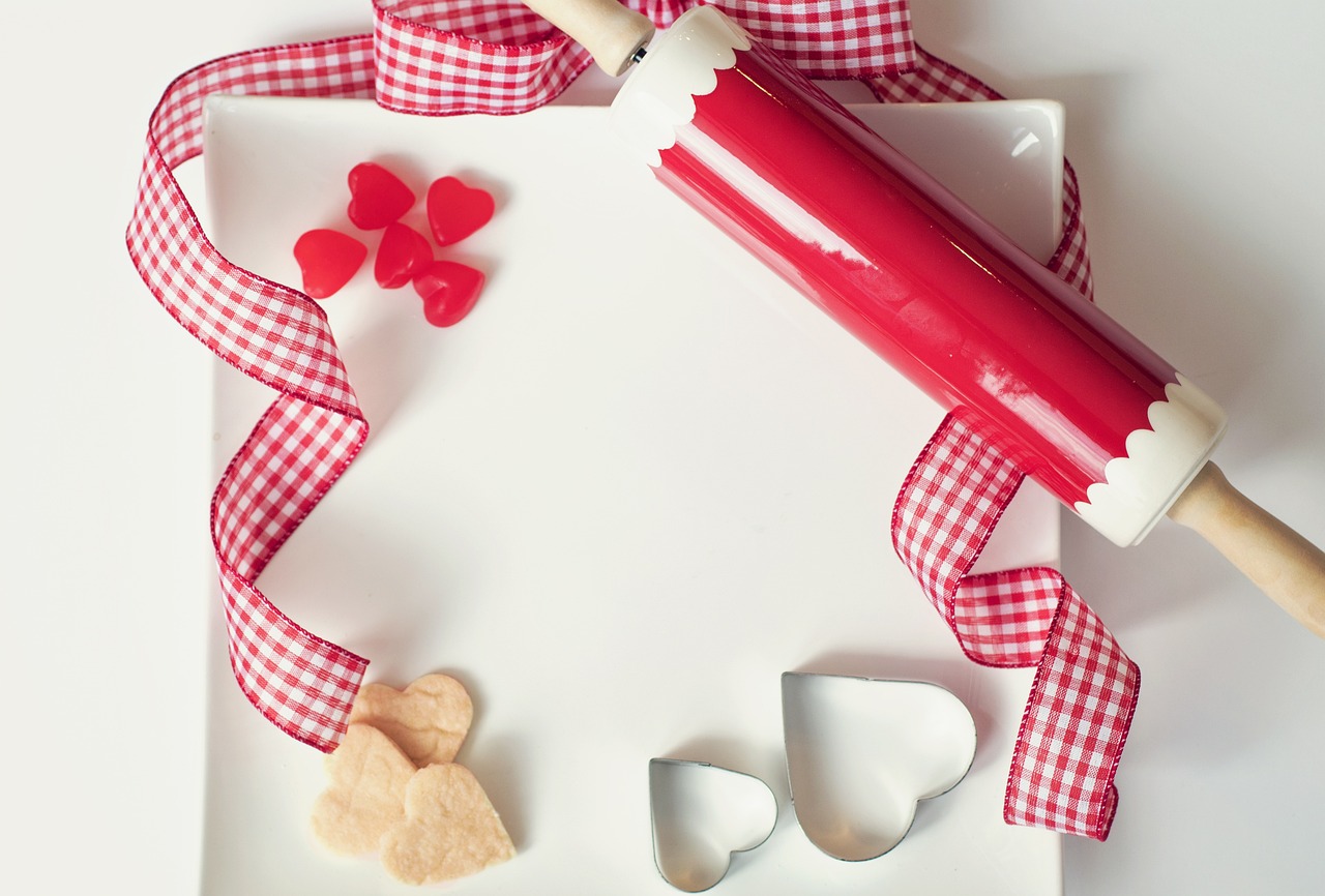 a red rolling pin sitting on top of a white plate, a picture, hearts, product introduction photo, hi-res photo, ribbon