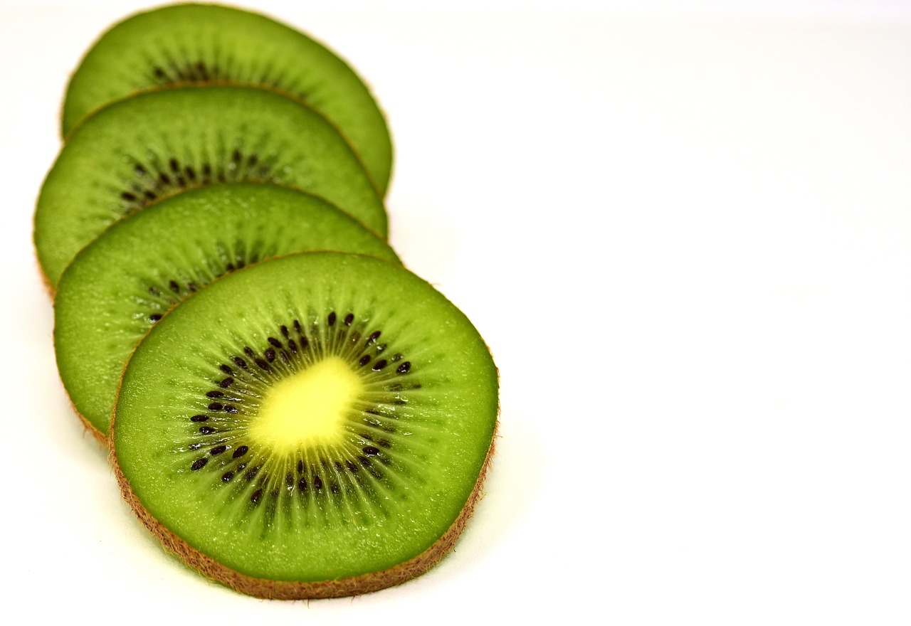 a group of kiwi slices sitting on top of each other, a stock photo, pexels, with a white background, difraction from back light, kermit, shot from a low angle