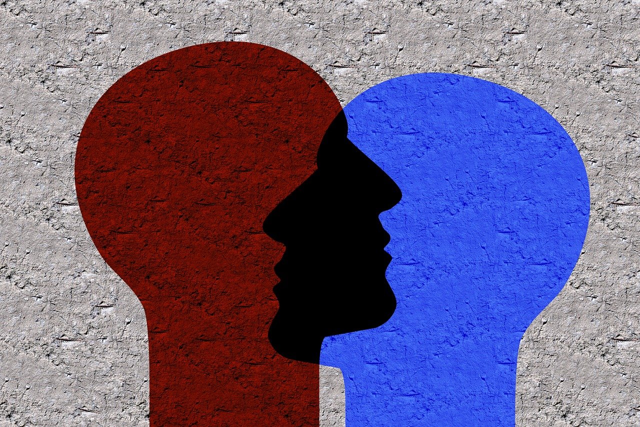 two silhouettes of a man and a woman facing each other, by Milton Menasco, trending on pixabay, folk art, colors red white blue and black, detailed face background detail, stock photo, speech