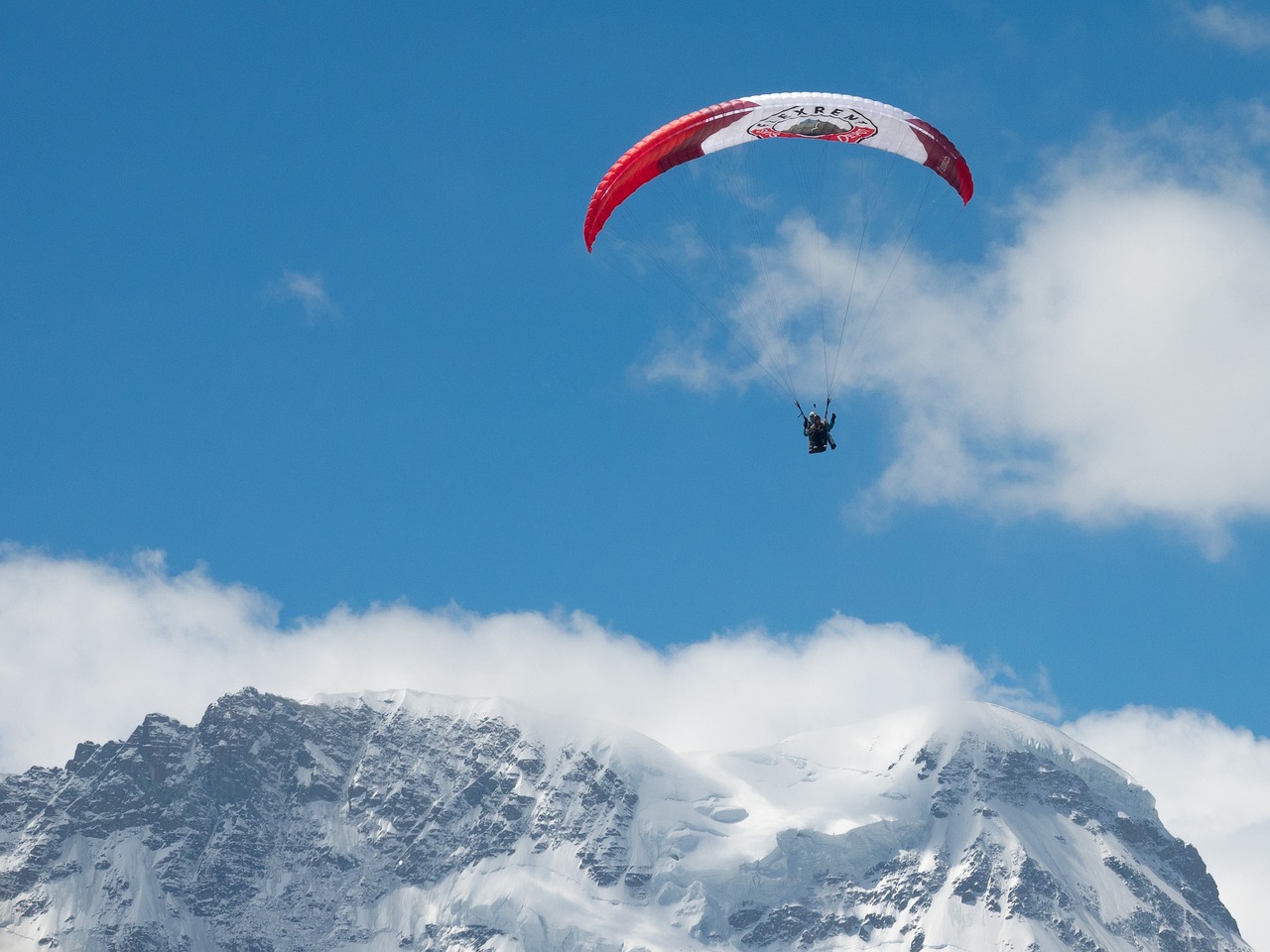 a person that is in the air with a parachute, a picture, by Matthias Weischer, shutterstock, chamonix, wallpaper - 1 0 2 4, panel, tournament