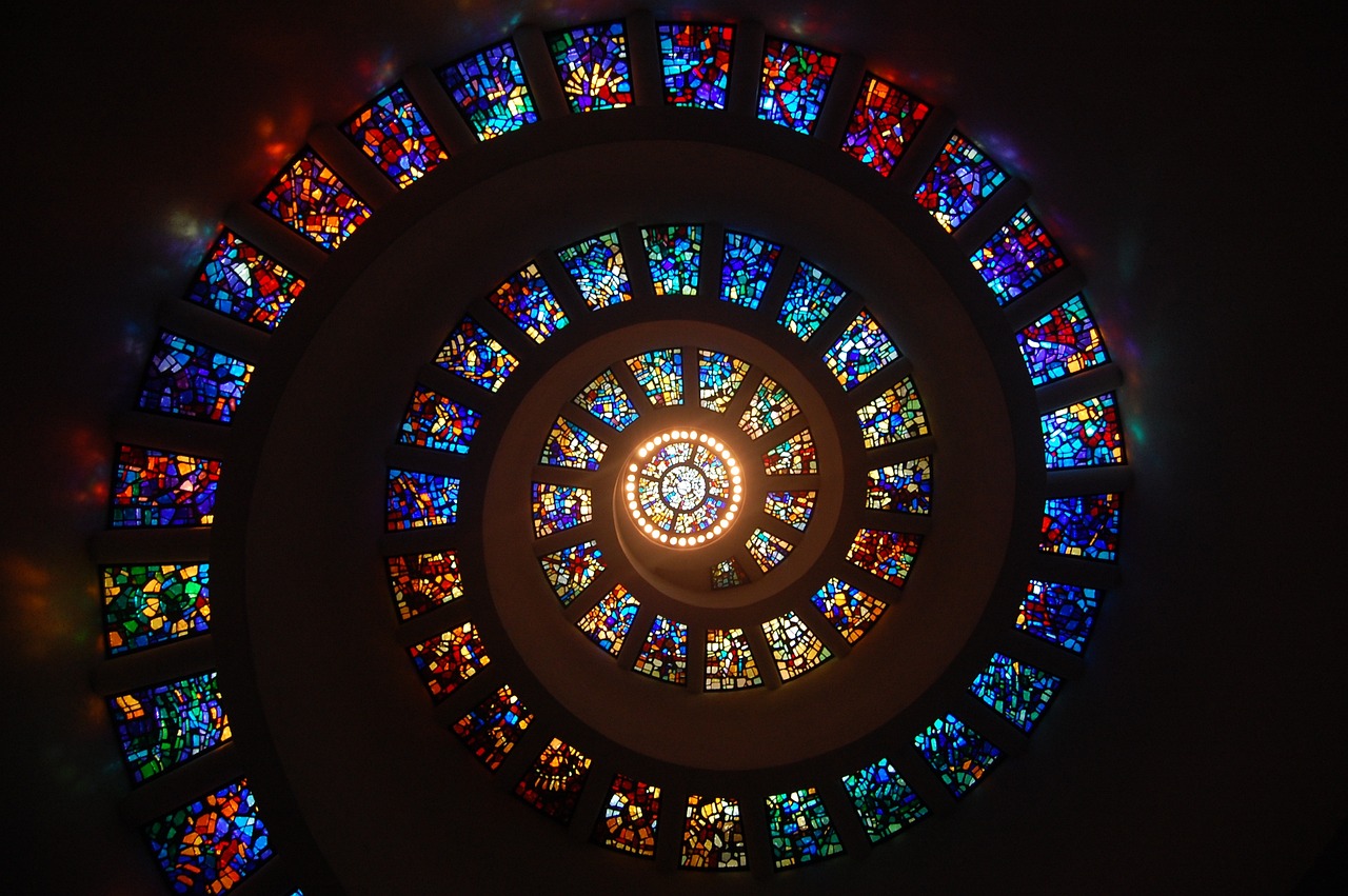 a circular stained glass window in a church, by Jon Coffelt, flickr, plasticized spiral flames, glass spaceship, infinite intricacy, pillar