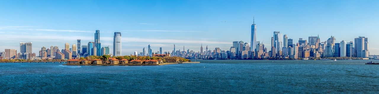 a large body of water with a city in the background, a photo, on liberty island, 15081959 21121991 01012000 4k, panoramic photography, shot on canon eos r5