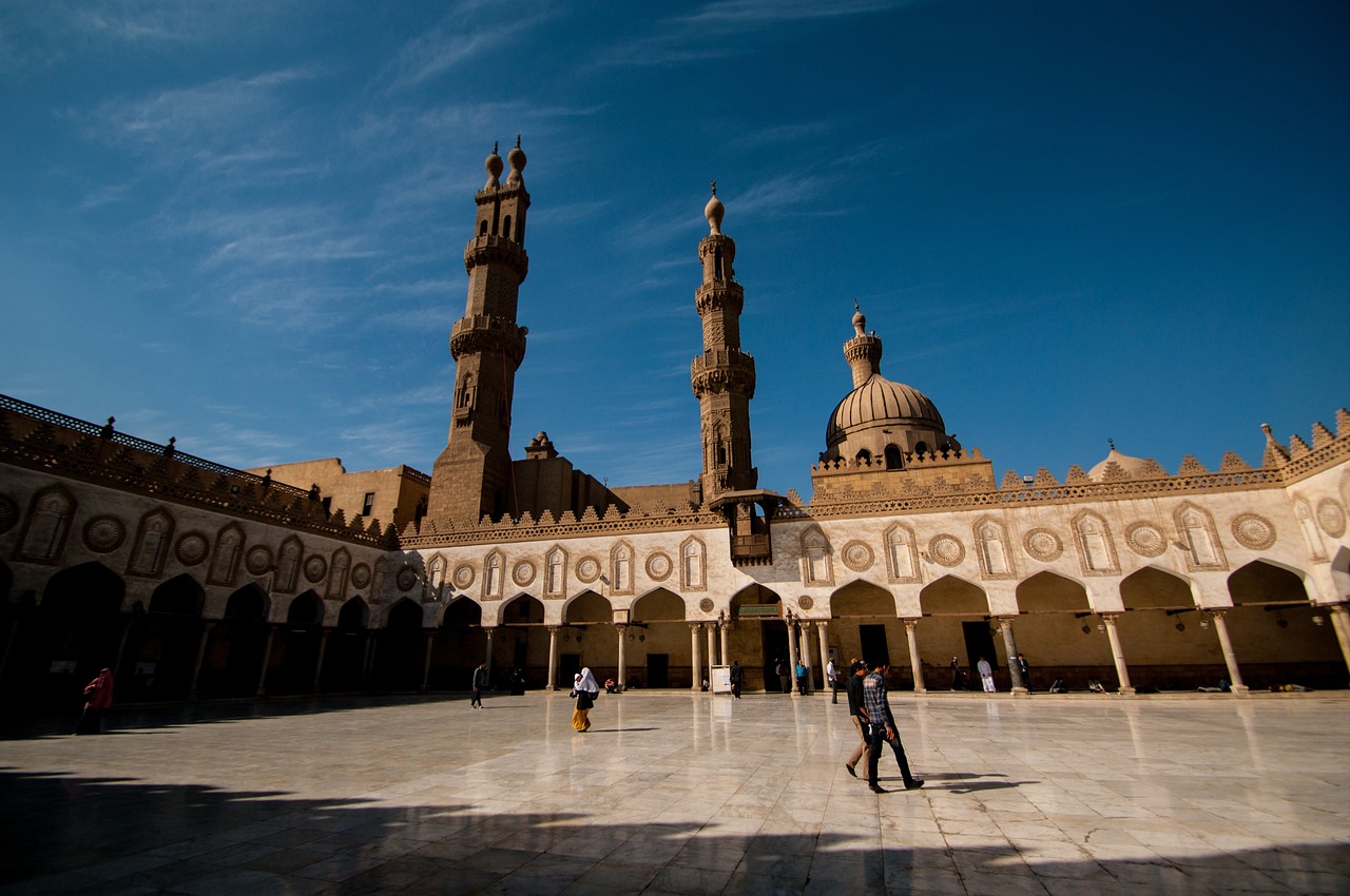 a couple of people that are standing in front of a building, a picture, by Youssef Howayek, shutterstock, arabesque, in egypt, a wide open courtyard in an epic, minarets, stock photo